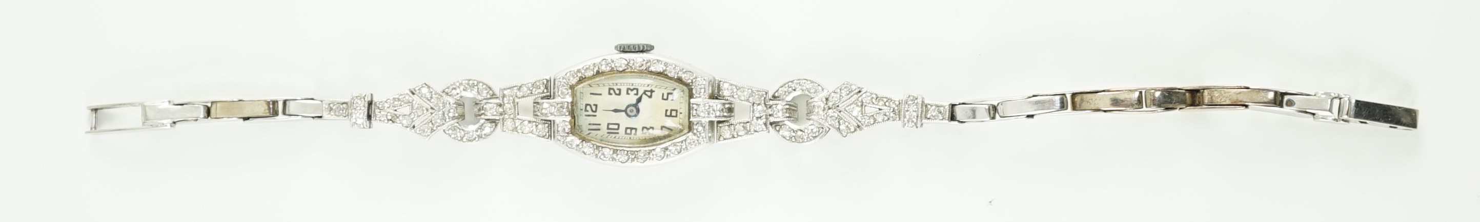 A lady's 1920’s platinum and round brilliant cut diamond set manual wind cocktail watch, on a white gold expanding bracelet